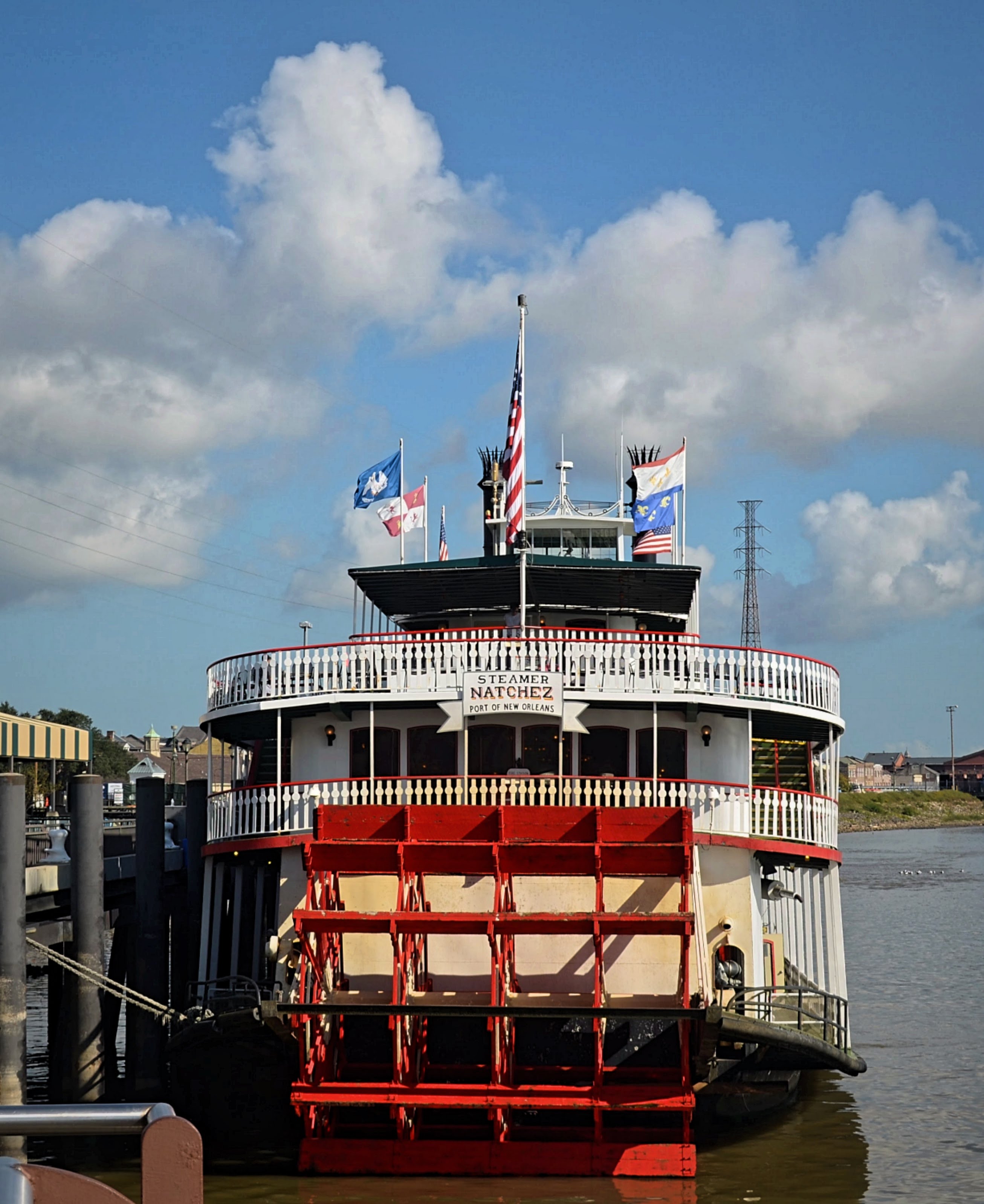 Red and white steamboat docked on river bank, new Orleans, travel blog, new orleans Louisiana, NOLA, the big east, new Orleans photography, Atlanta photographer, new Orleans travel, new Orleans travel blog, traveling blog